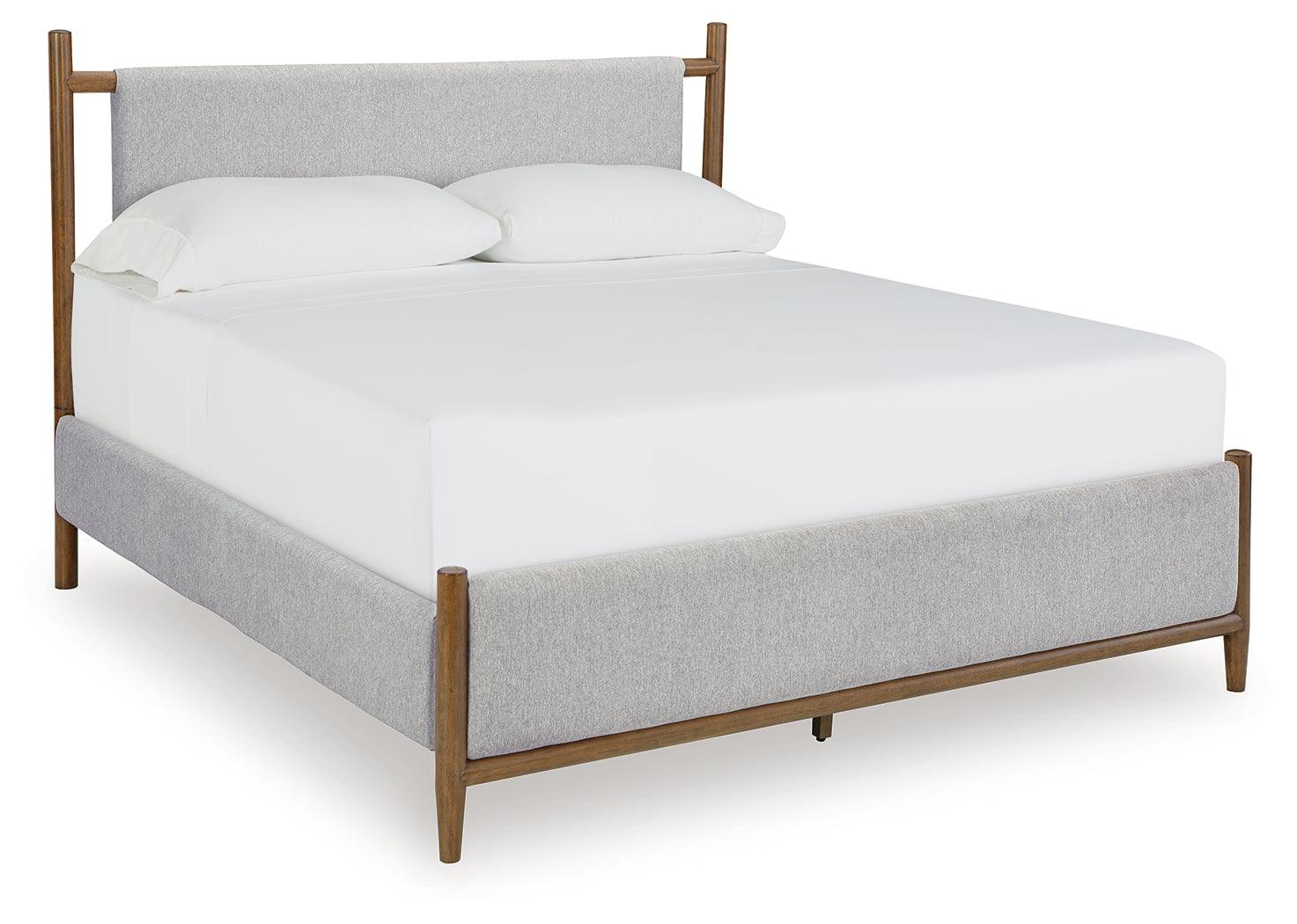Side angle of Lyncott brown king panel bed highlighting tapered legs