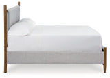 Detail of tapered legs on Lyncott Brown Queen Upholstered Panel Bed