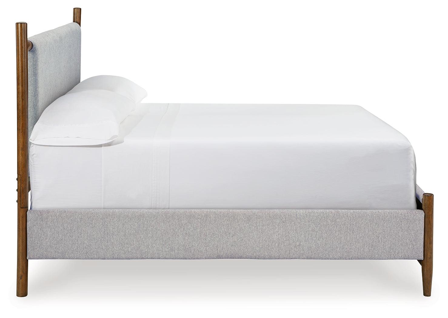 Detail of tapered legs on Lyncott Brown Queen Upholstered Panel Bed