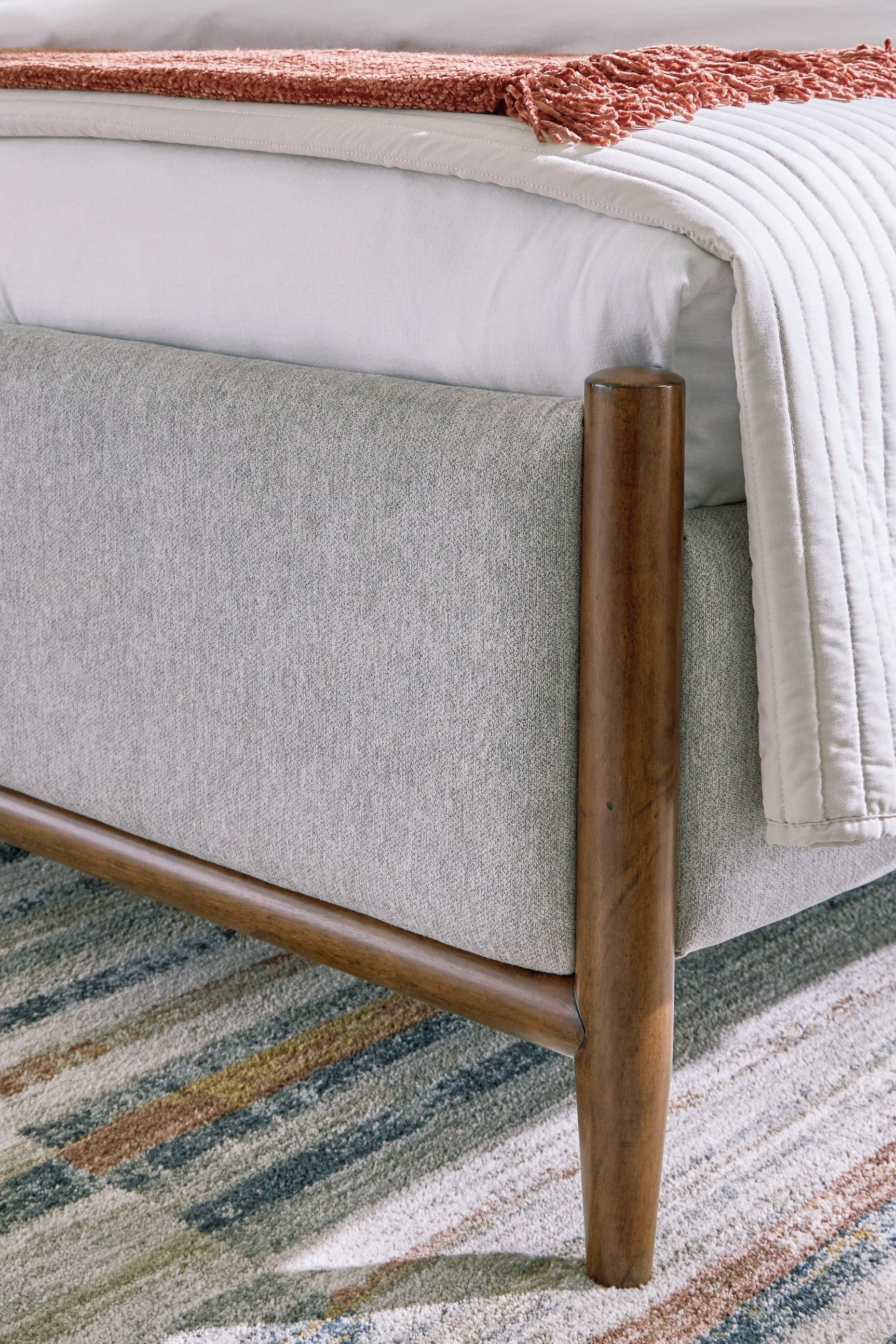 Elegant brown finish on solid wood frame of Lyncott bed