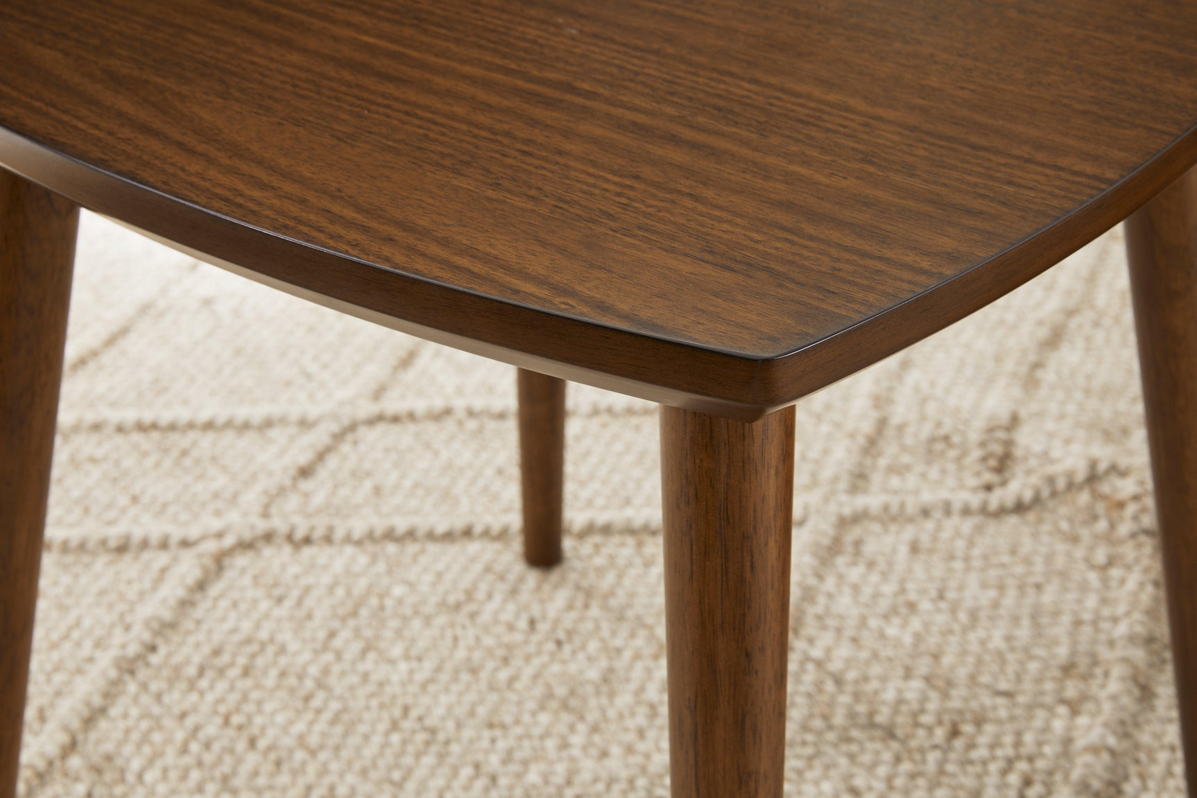 Lyncott Medium Brown Wood Table Set styled with sofa and rug