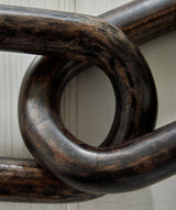 Close-up detail of the distressed black finish on Mardelby sculpture