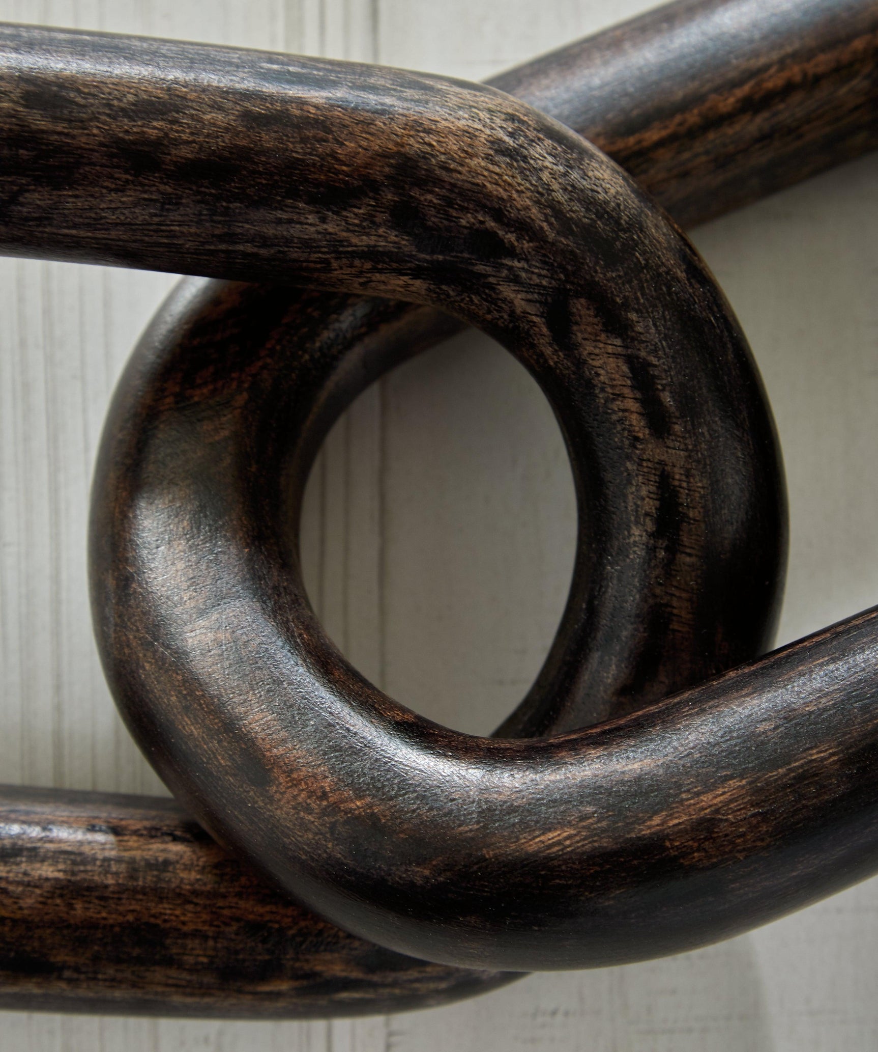 Close-up detail of the distressed black finish on Mardelby sculpture