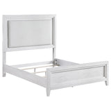 Side angle showing distressed white finish and upholstery