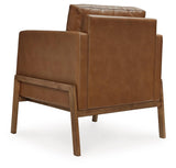 Numund accent chair close-up of caramel faux leather upholstery