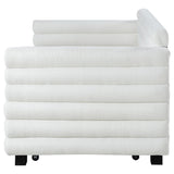 White boucle upholstered twin daybed with trundle, room setting