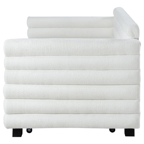 White boucle upholstered twin daybed with trundle, room setting