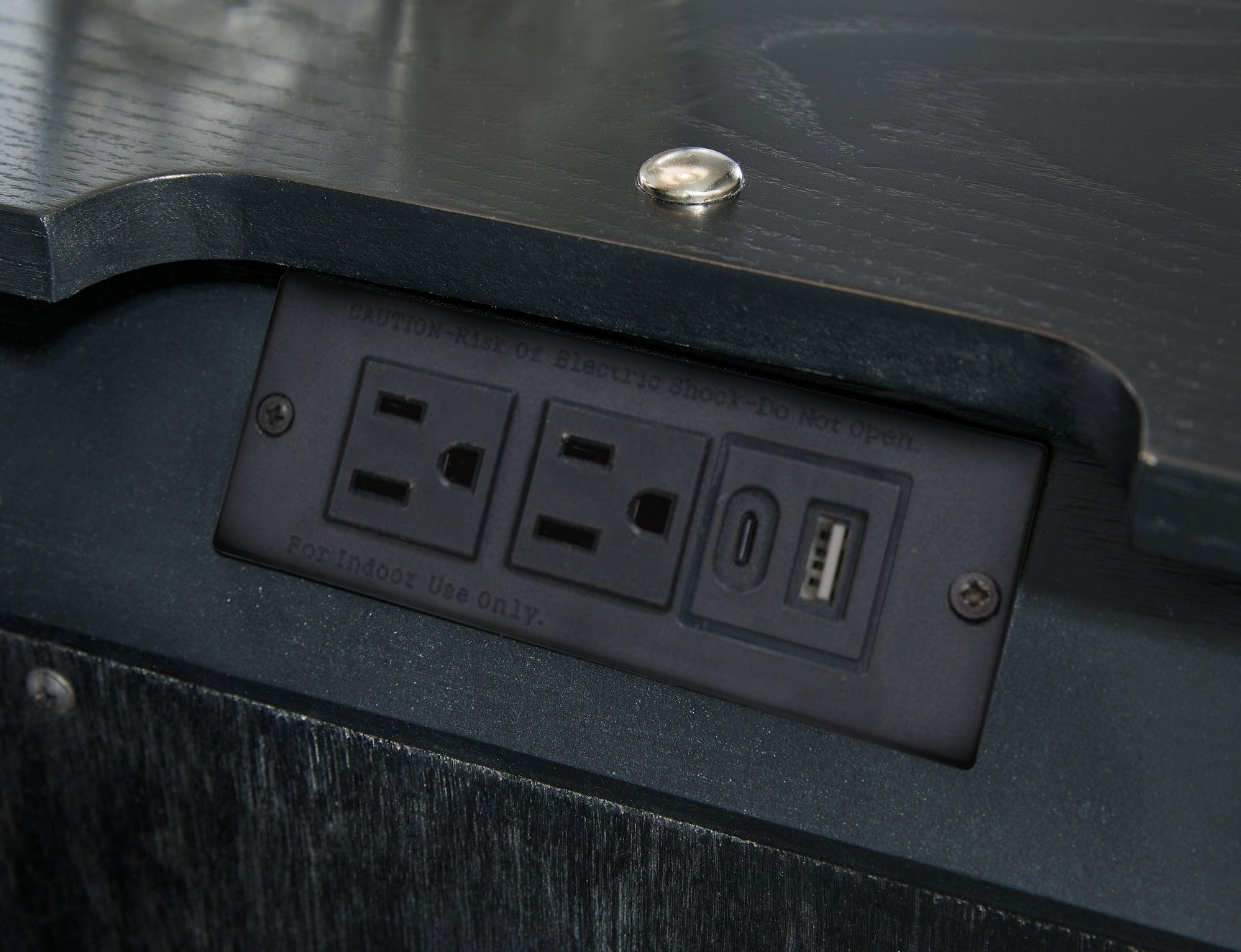 Nightstand in bedroom setting highlighting black textured wood grain finish