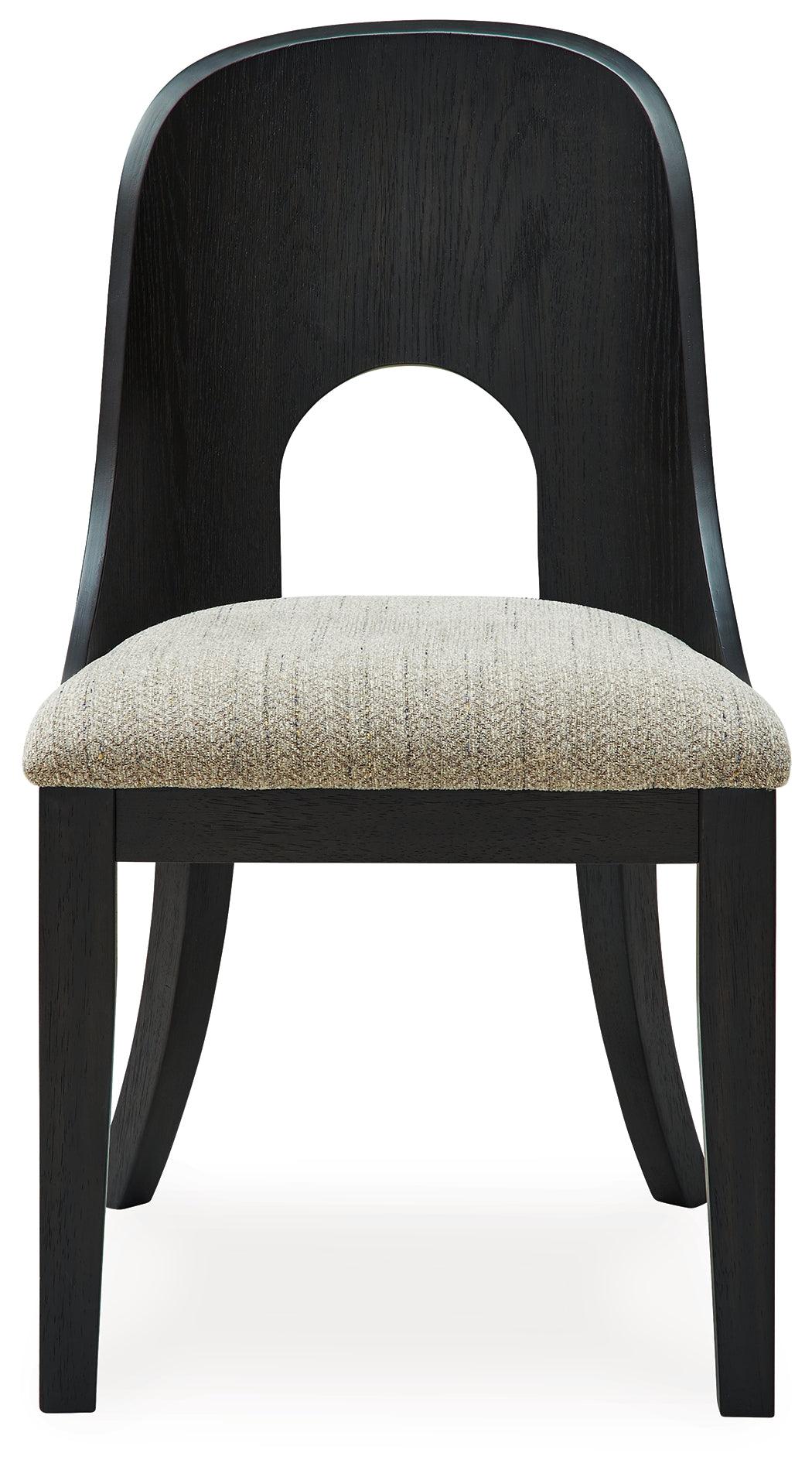 Dining chair showing black wood legs and curved backrest
