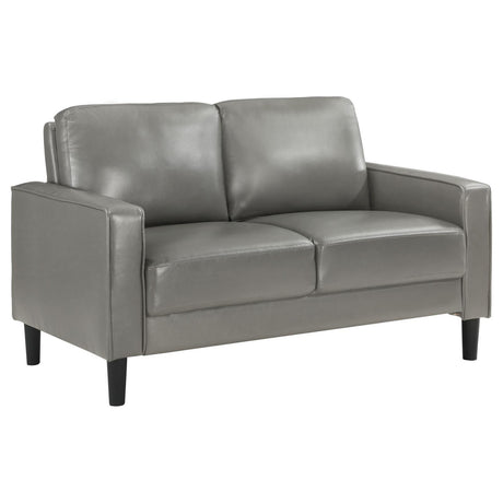 Ruth Loveseat front angle showing grey leatherette upholstery and track arms