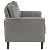 Detailed view of loveseat arm with faux leather texture