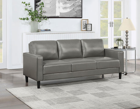side view of Ruth grey faux leather sofa showing upholstery detail