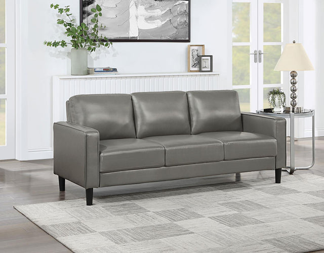 side view of Ruth grey faux leather sofa showing upholstery detail