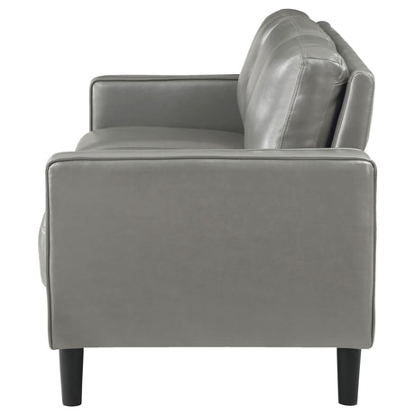 side angle of Ruth grey faux leather sofa showing seat cushions