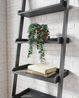 Detailed view of black powder-coated metal frame and engineered wood shelves on Yarlow leaning bookcase