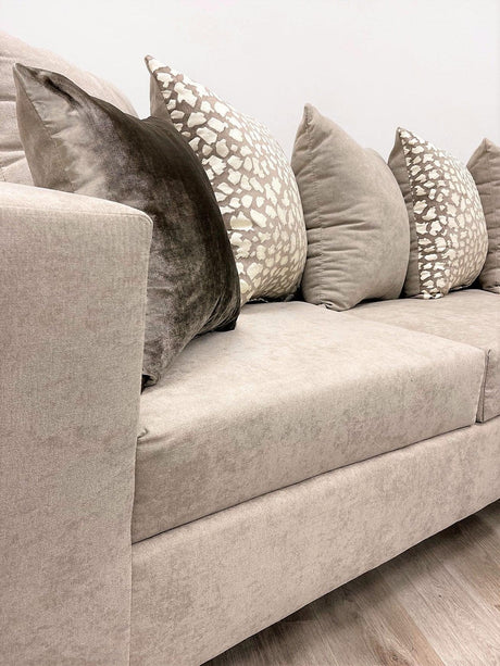Side view of Hollywood Beige chenille fabric upholstered sectional sofa with chaise