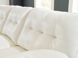 Close-up of tufted faux leather upholstery on Ashley RAF Chaise sectional