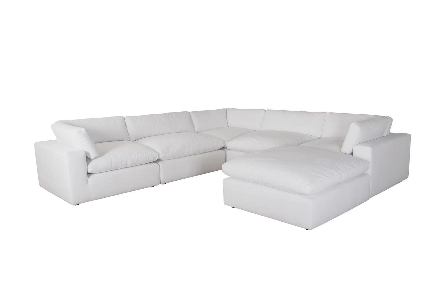 Room setting showcasing XL Cloud White sectional sofa and ottoman