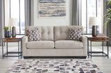 Pebble tufted sofa sleeper showcasing fabric texture and design - side view
