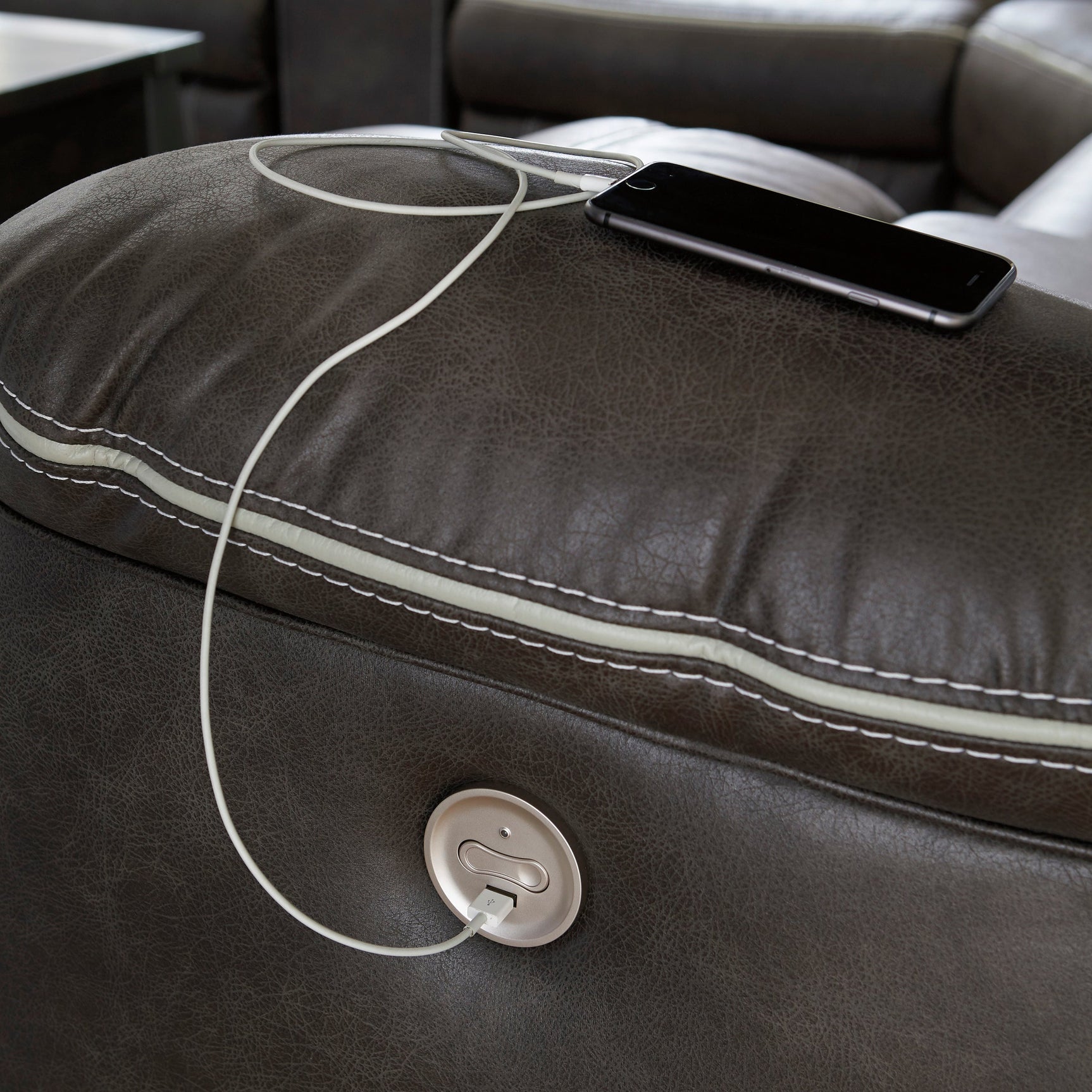 Close-up of USB charging port and power control on sectional