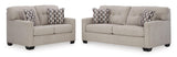 Close-up detail of tufted pebble fabric upholstery on Ashley Pebble Loveseat