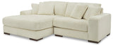 Side view of ivory fabric upholstered 2-piece sectional sofa with left arm facing chaise
