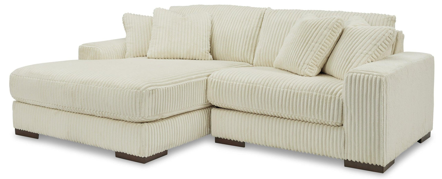 Side view of ivory fabric upholstered 2-piece sectional sofa with left arm facing chaise