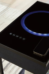 Accent table powering devices with visible cables and speaker components