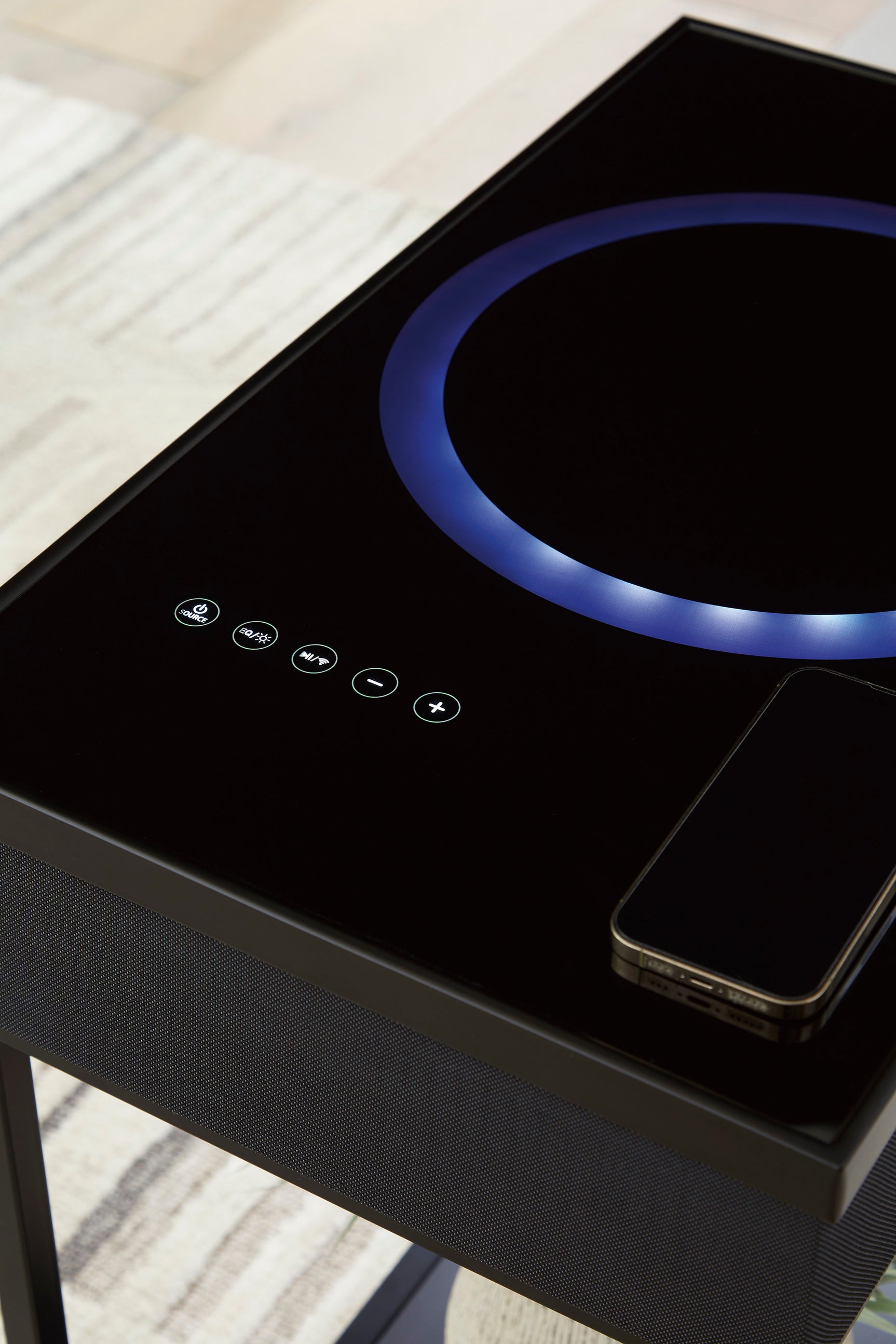 Accent table powering devices with visible cables and speaker components