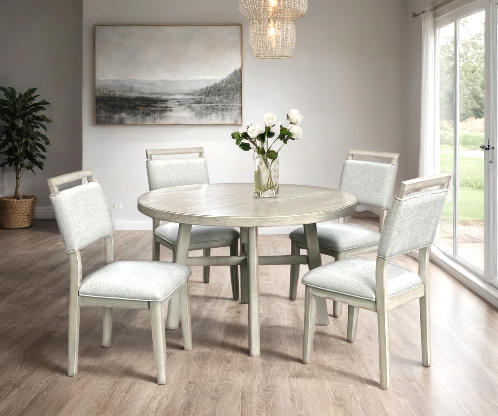 Room view of Domino light gray round dining table with four chairs in dining setting