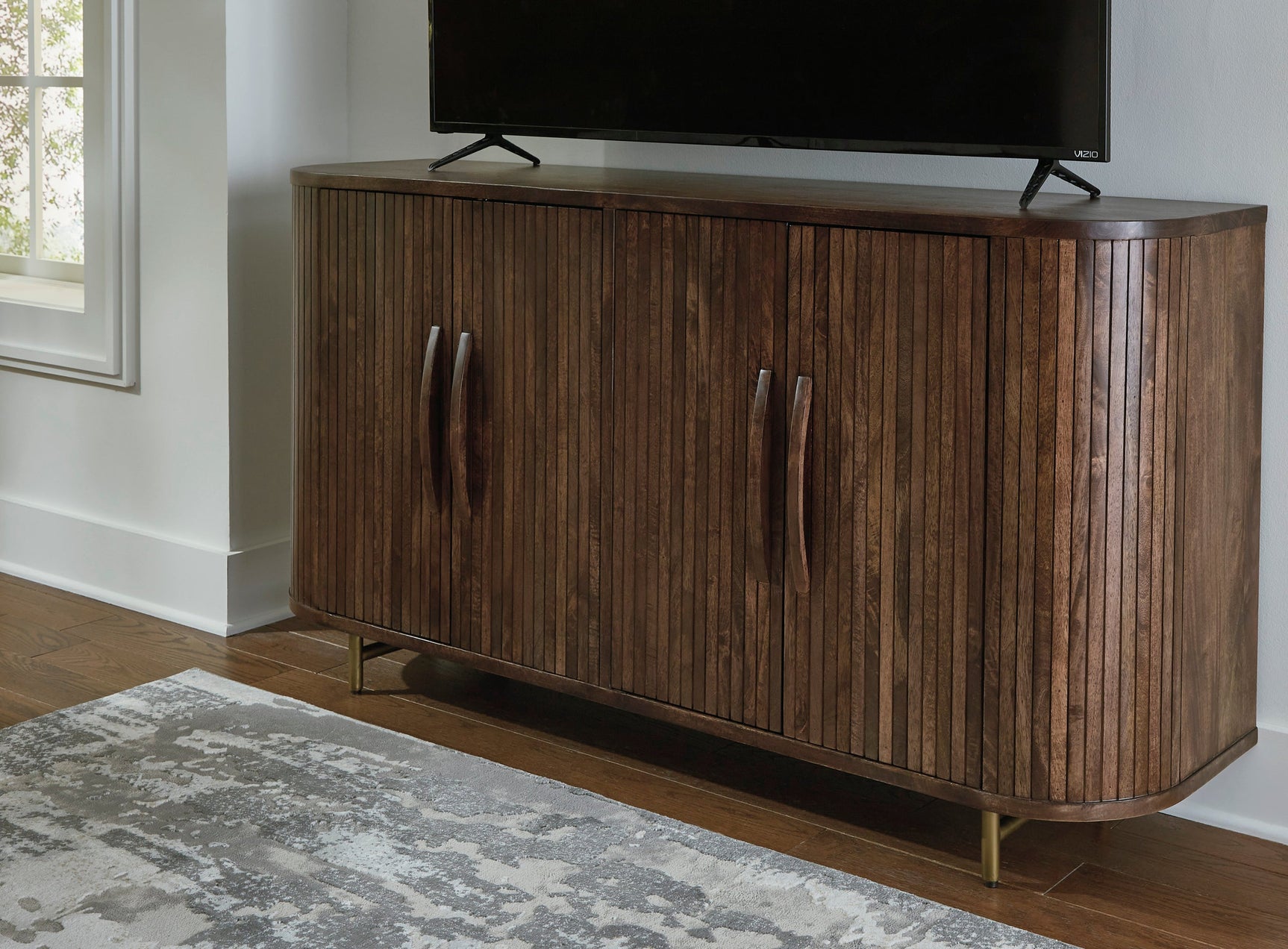 Side view of accent cabinet showing curved detail and goldtone base