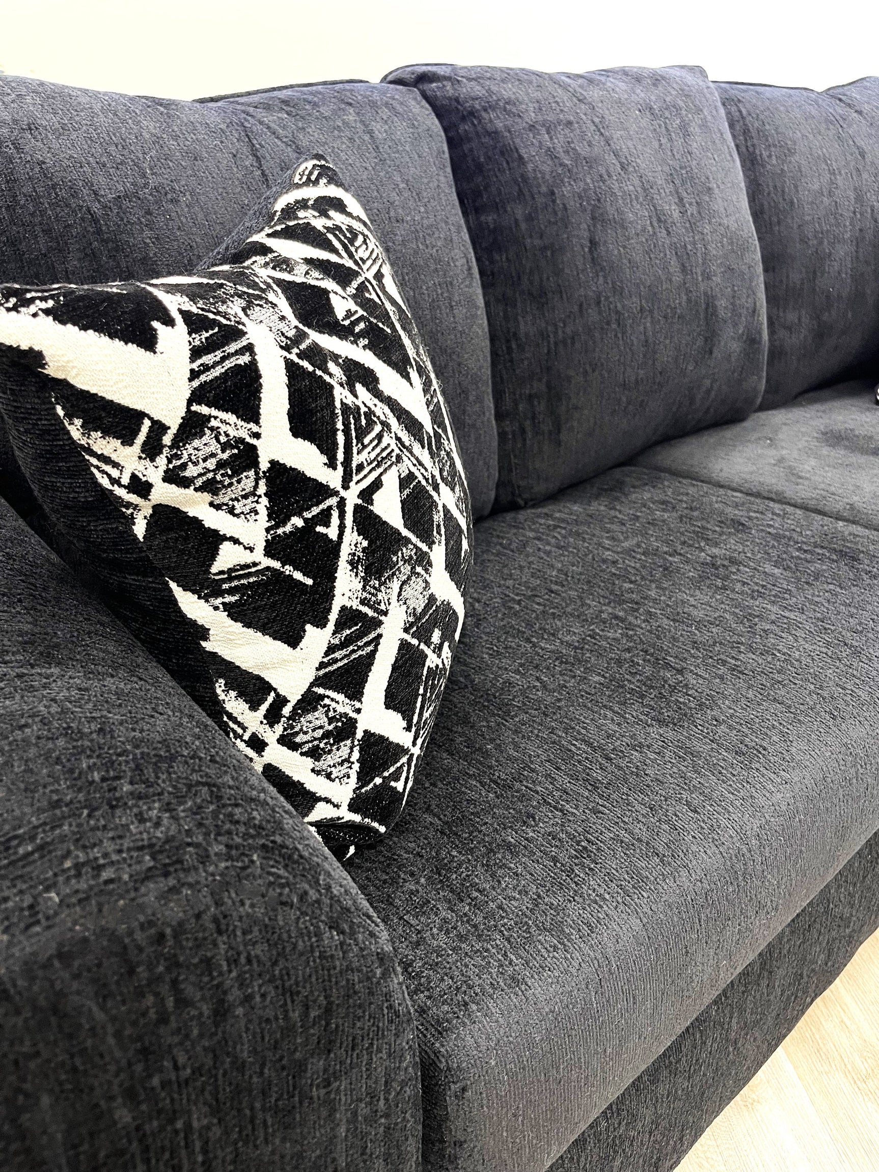 Close-up detail of chenille-like black upholstery on Tuten Living Room Set