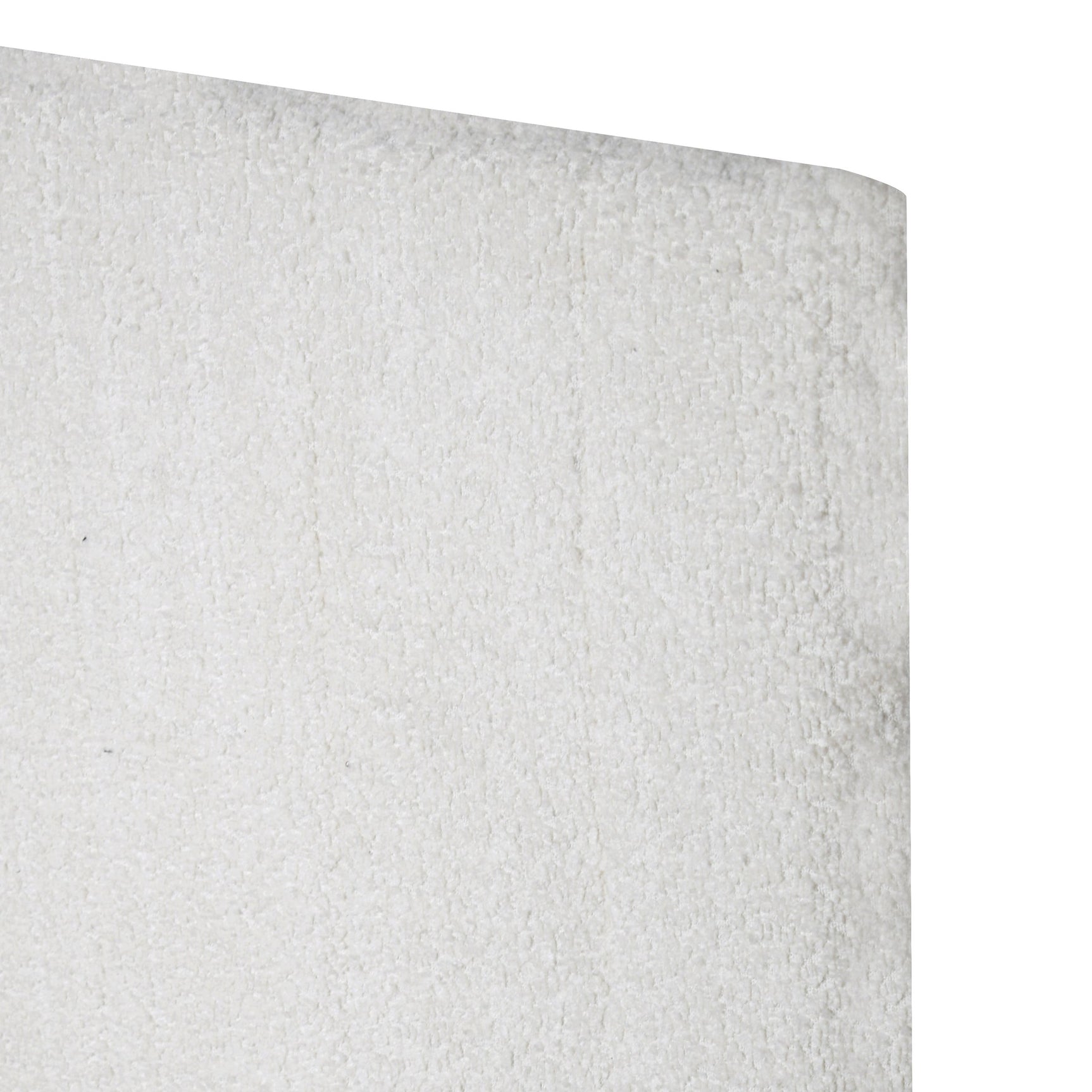 Close-up of white upholstered headboard