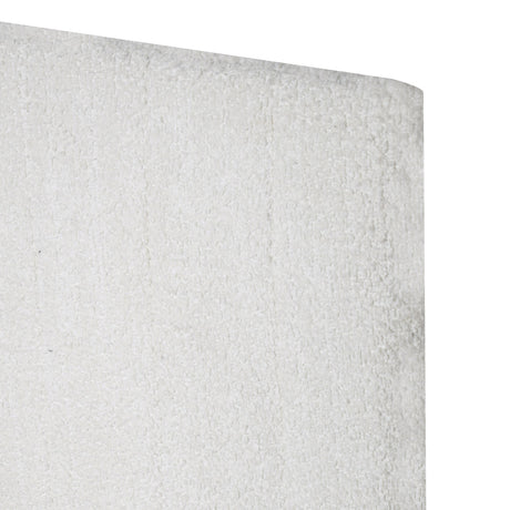 Close-up of white upholstered headboard