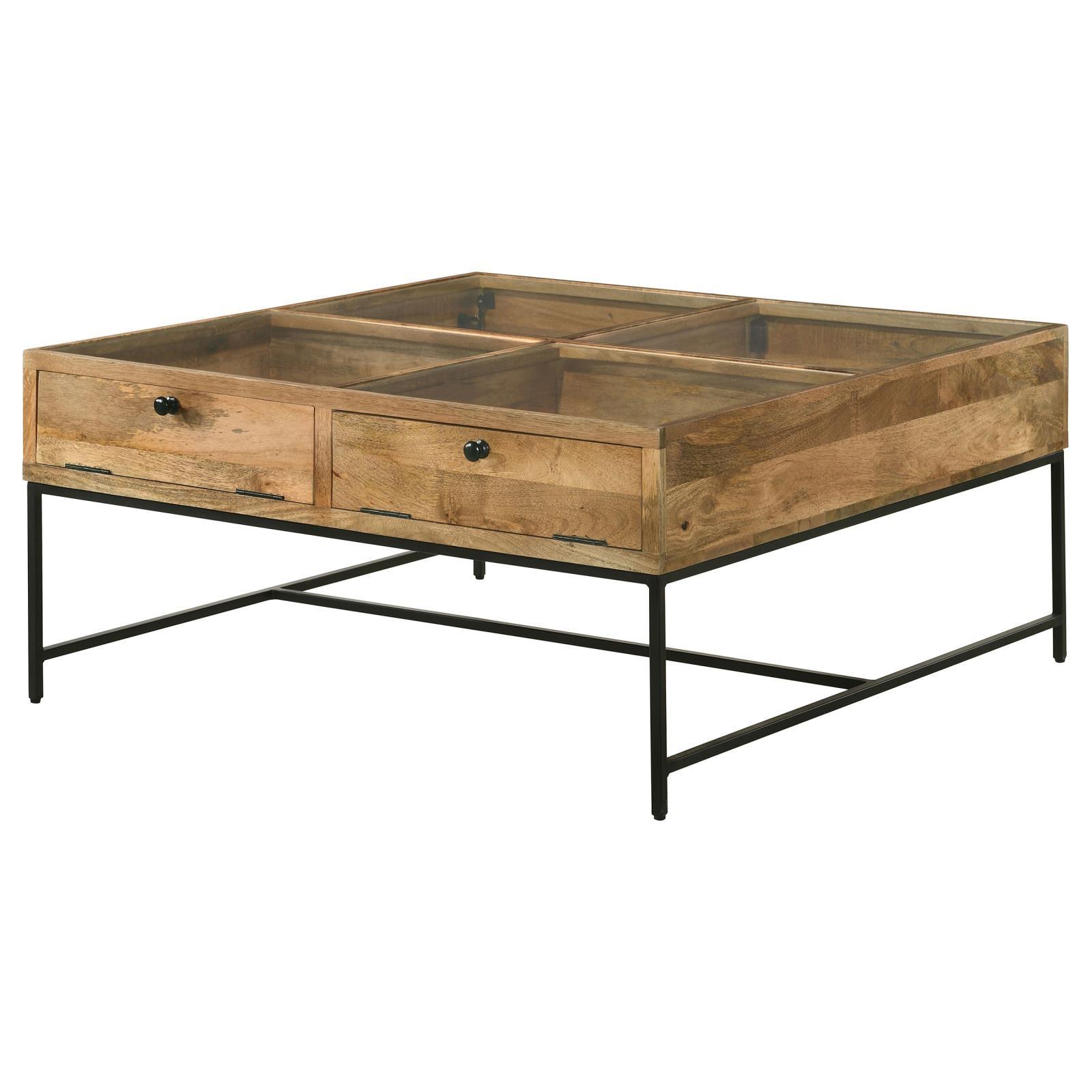 Black iron base of Stephie coffee table under honey brown mango wood top