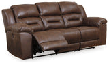 Power rocker recliner in chocolate faux leather with gentle rocking motion