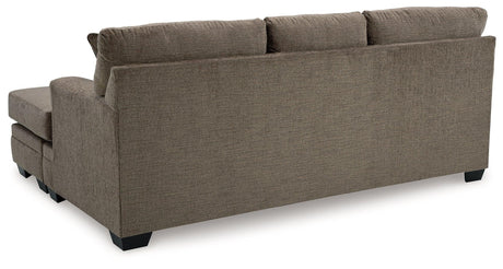 Exposed feet with faux wood finish on sofa chaise