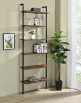 Close-up of six open walnut finish shelves