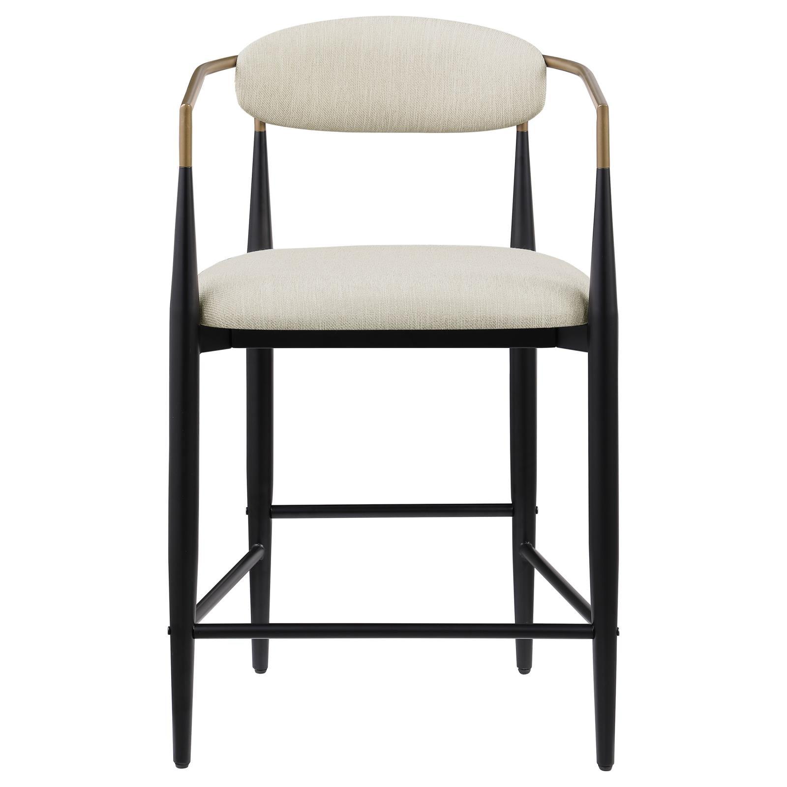 Close-up of beige upholstered seat and back on Tina metal bar stool