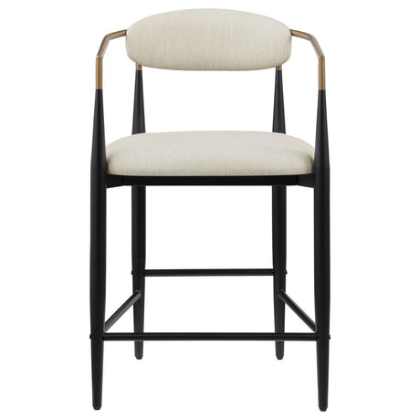 Close-up of beige upholstered seat and back on Tina metal bar stool