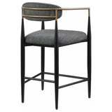 Side angle showing slim rounded support and black metal base of Tina stool