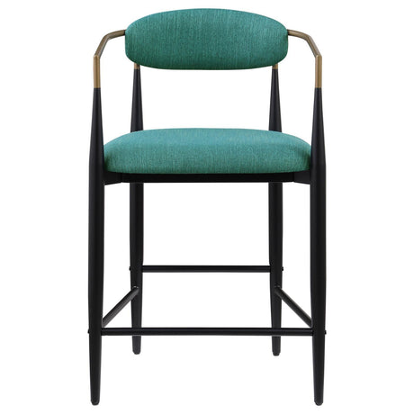 Tina metal base with footrest featured on green upholstered stool