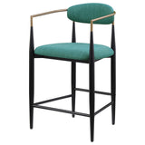 Tina green upholstered counter height bar stools showing tapered black metal legs
