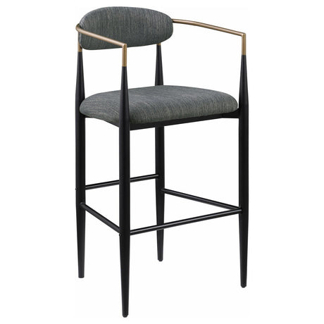 Close-up of Tina bar stool fabric upholstery and bentwood armrest