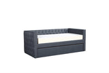 Close-up of tufted gray fabric upholstery on Trina daybed arm