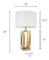 White and gold table lamp displayed on furniture